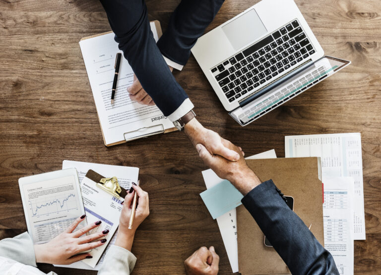 Business people shaking hands together